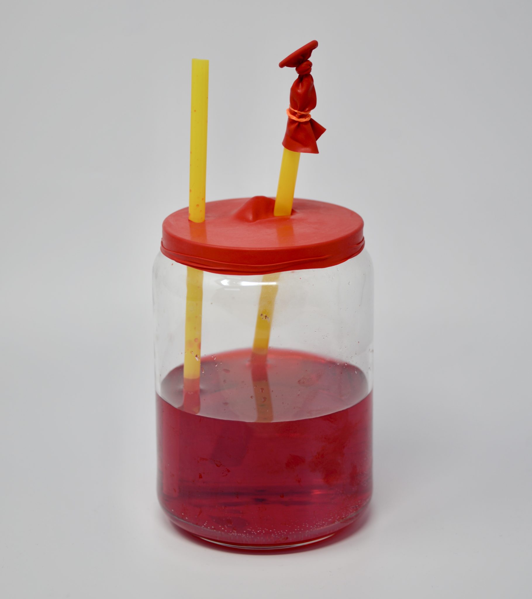 pumping heart model made with a jar, straw and balloon