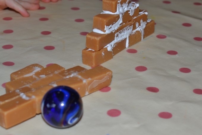 sections of a wall made from fudge and icing for a candy house STEM challenge