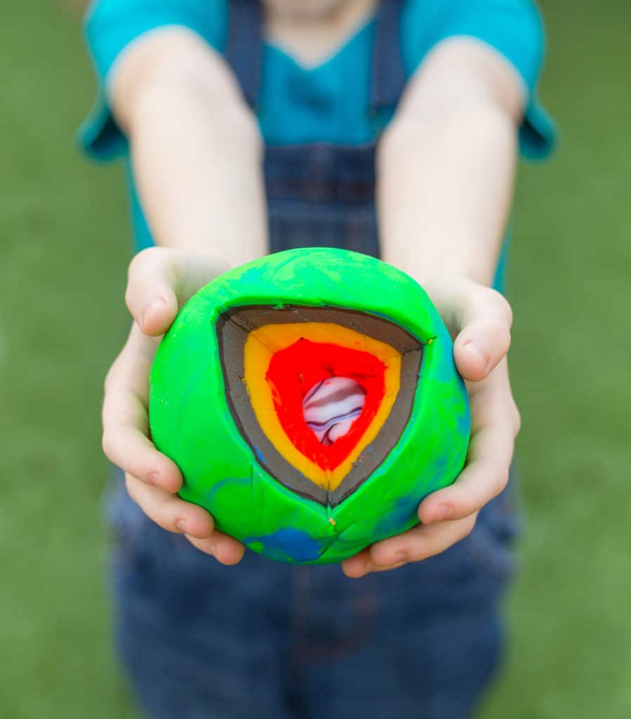 Model of the earth using a marble and playdough to illustrate the different layers.