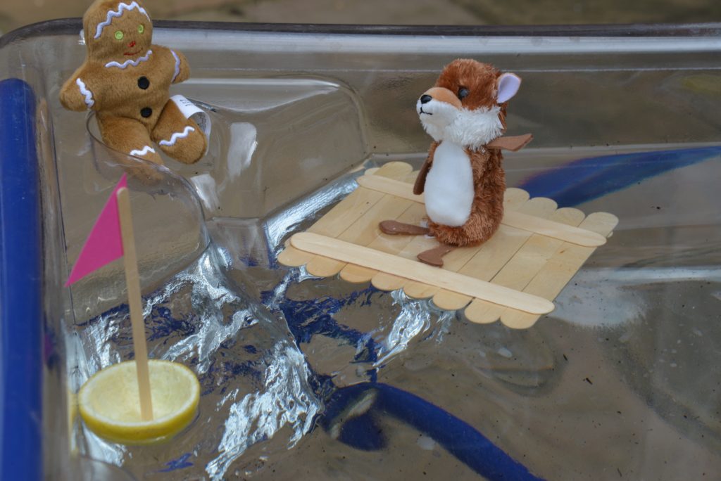 Lolly stick raft floating on water for a gingerbread Man science activity