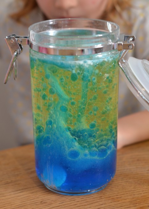 lava lamp for kids made with blue water, a layer of vegetable oil and an alka seltzer to create bubbles