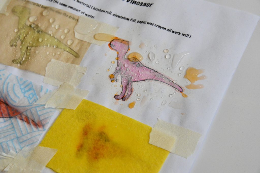 Image of dinosaurs on a sheet of paper covered with different materials for a waterproof activity