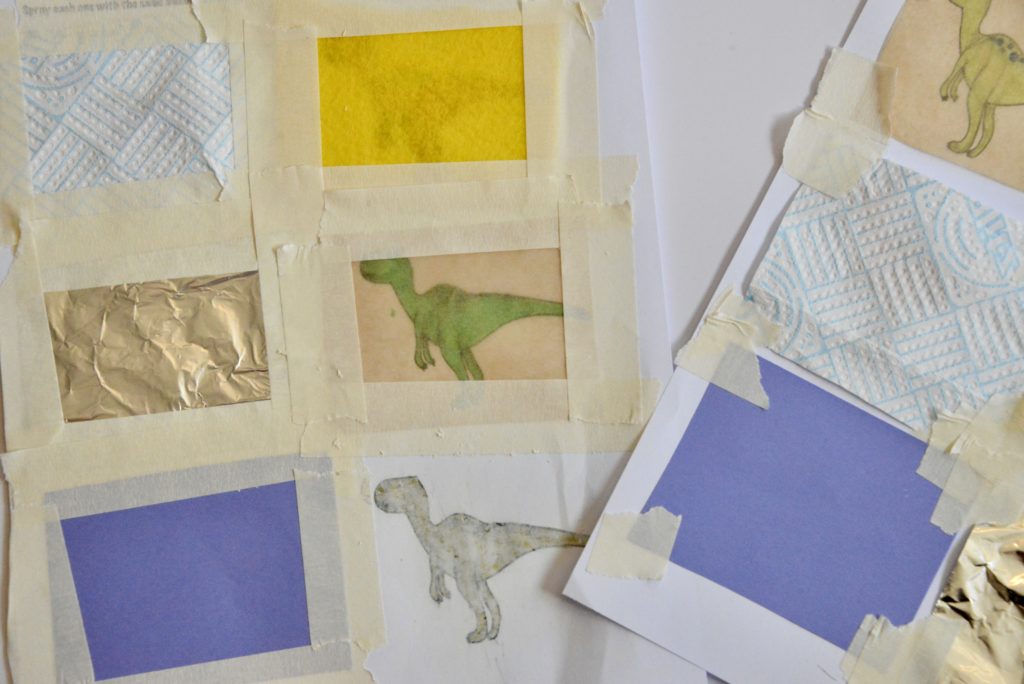 image of a sheet with dinosaur images printed on it. Each image is covered with a different material as part of a waterproof investigation.