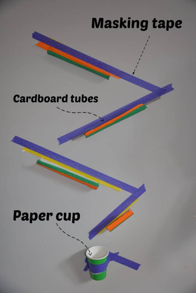 marble run made by taping cardboard tubes to a wall