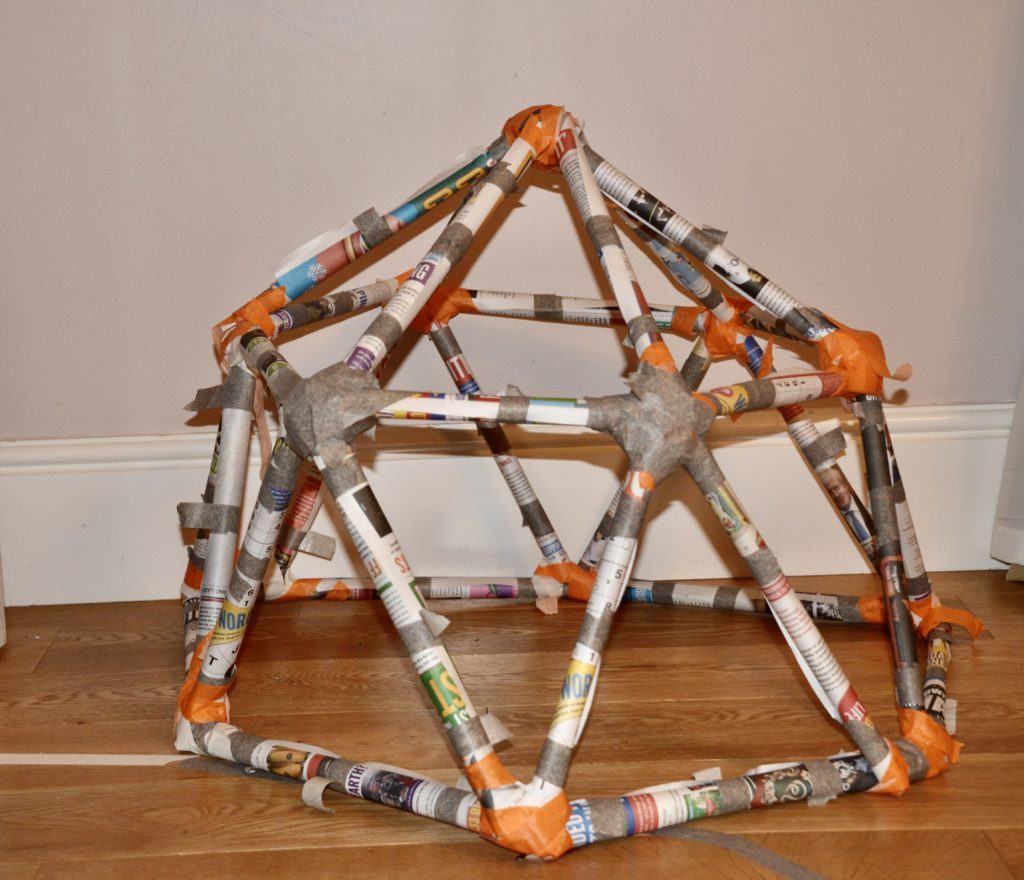 structure made with rolls of newspaper and tape
