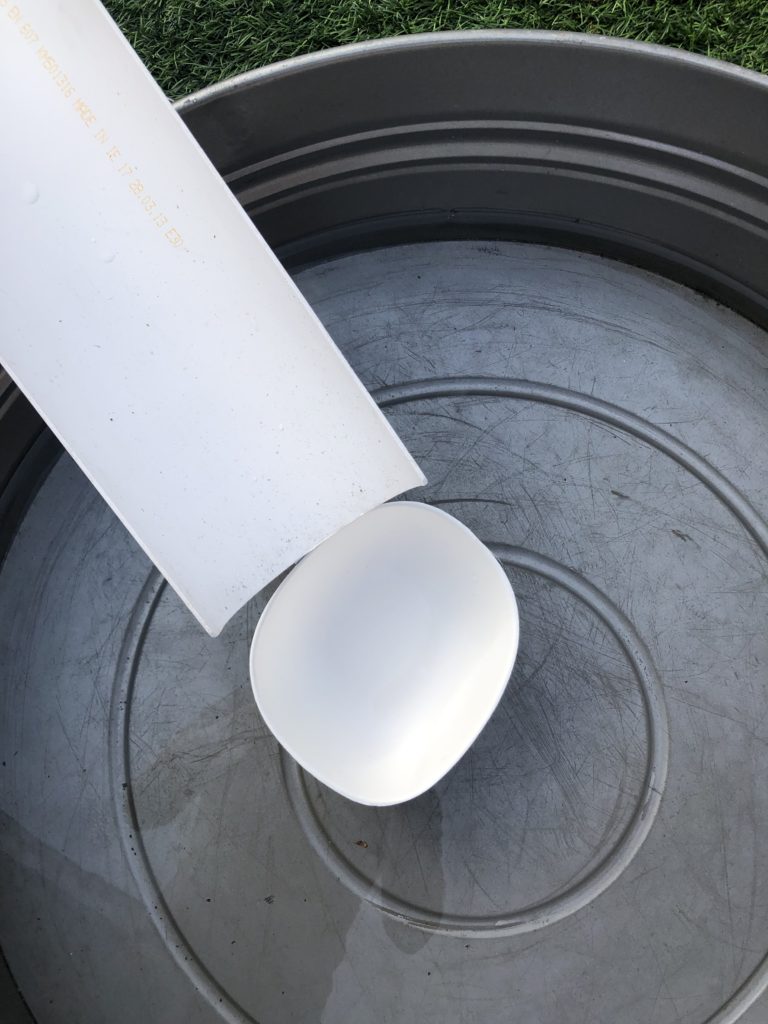 tub of water, with a pipe and cardboard bowl as part of a chain reaction