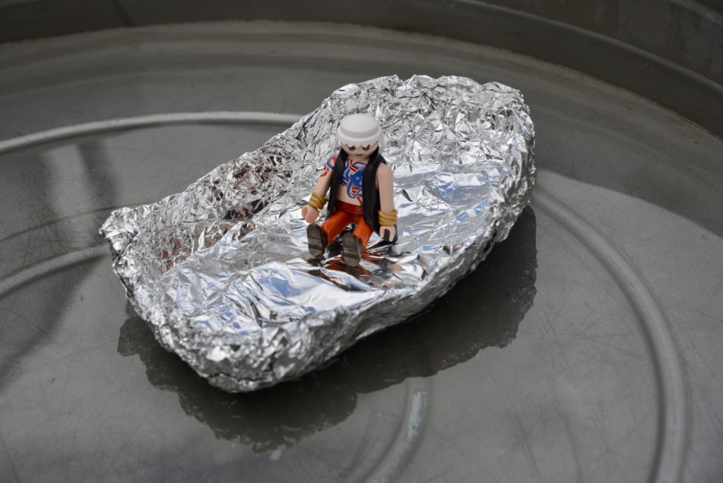 Image of a boat made from aluminium foil with a playmobil person inside