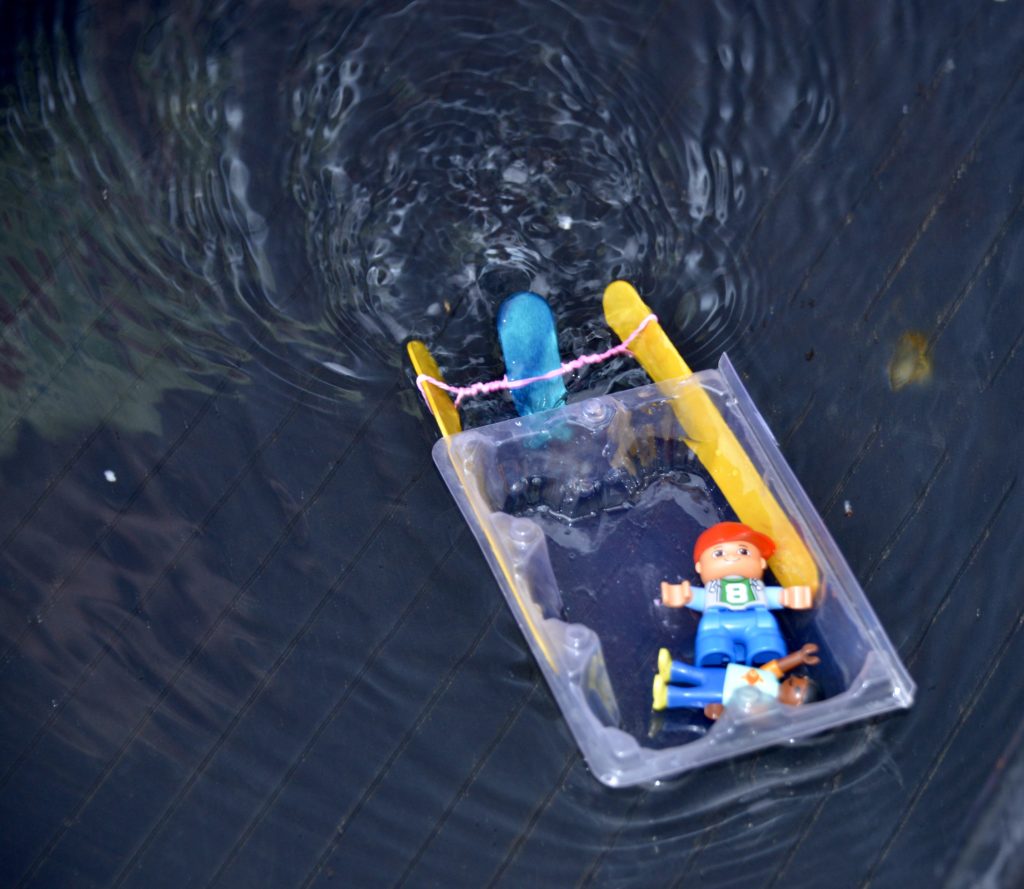 elastic band powered boat in water