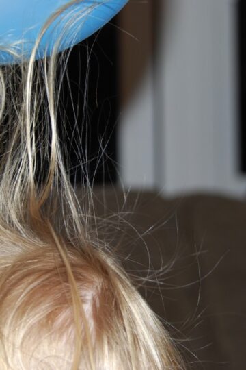 hair standing on end because of an electrostatically charged balloon