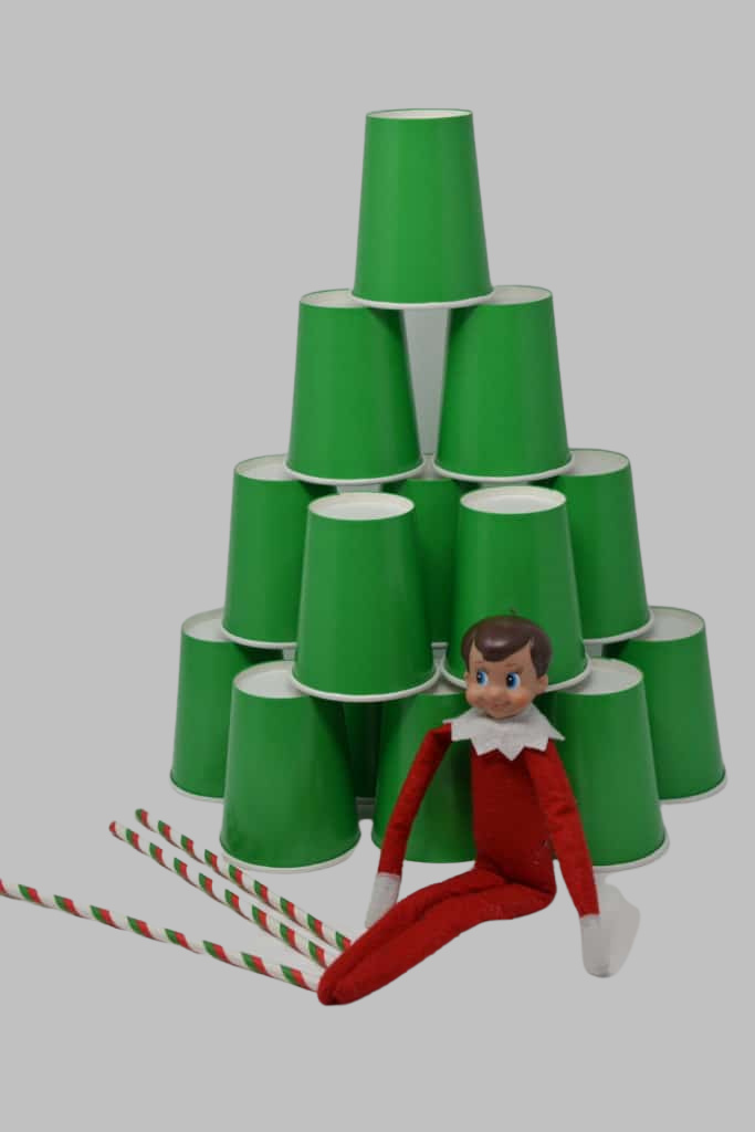 Tree made from green cardboard cups with an elf sat next to it