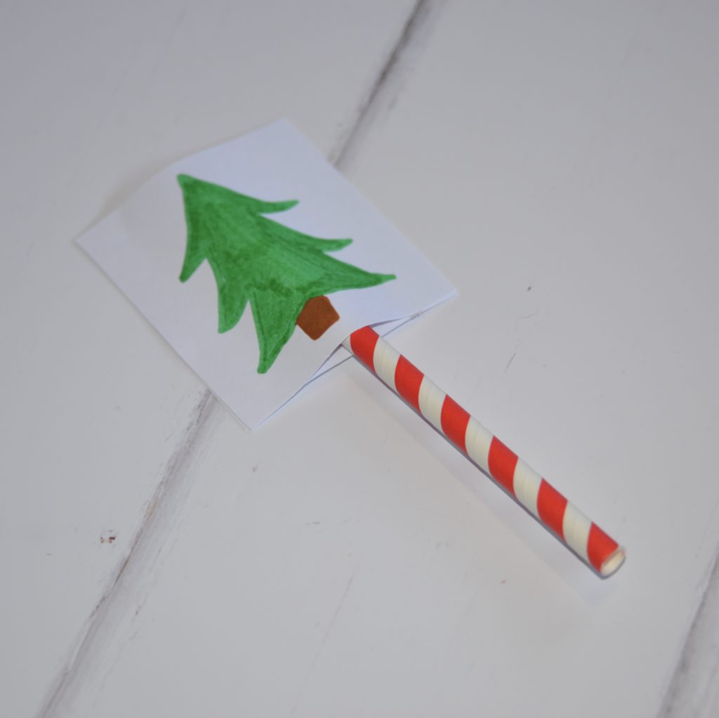 a Christmas optical illusion made with a straw and two pieces of cardboard