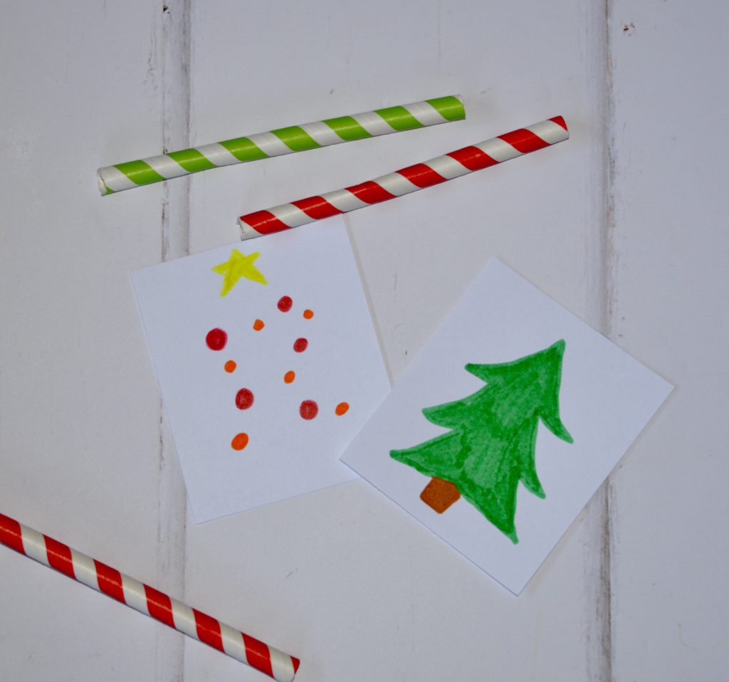 pieces for making a Christmas optical illusion with cardboard and two straws