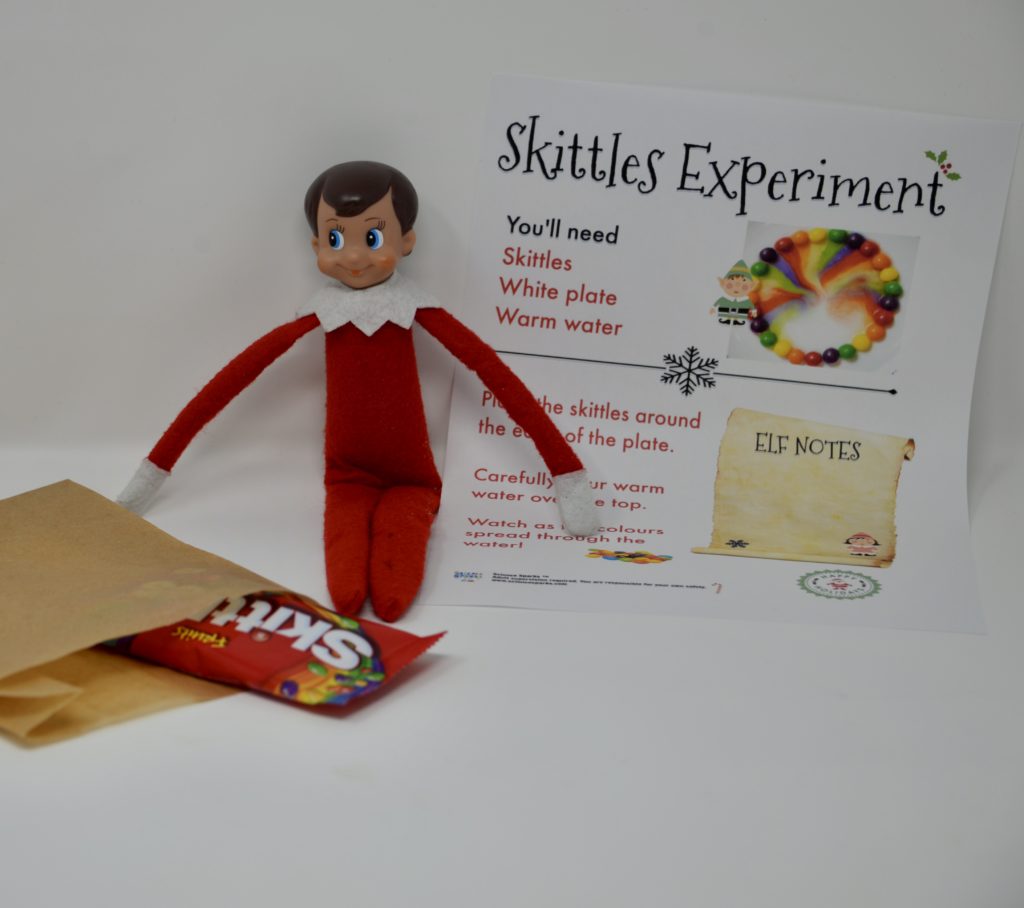 Elf on the shelf with a bag of skittles and instructions for the activity.