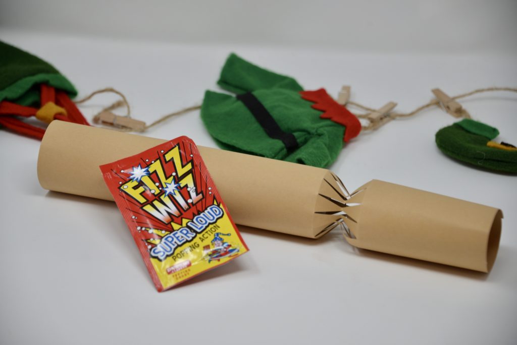 homemade crackers with a science activity inside. Image shows an empty cracker and a packet of fizz wizz popping candy