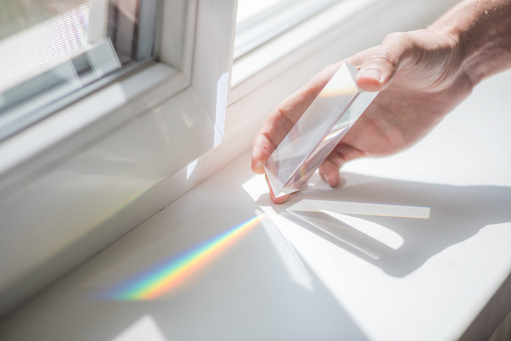 prism on a windowsill splitting light into it's constituent colours