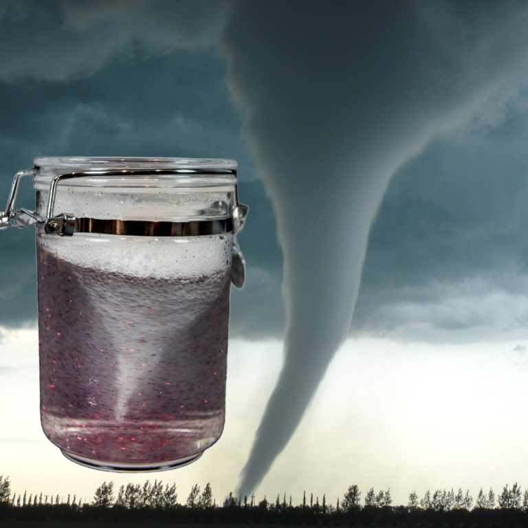 Image of a tornado in a jar with a background of a real tornado