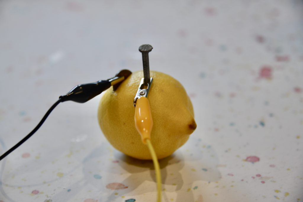 lemon battery with a copper coin and zinc nail