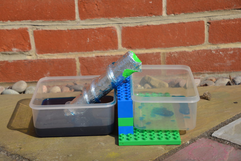 DIY Archimedes Screw made using DUPLO for the incline, a cardboard tube and clear tubing