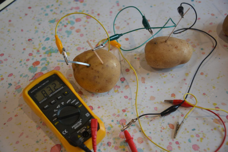 2 potatoes and a voltmeter showing the current passing through