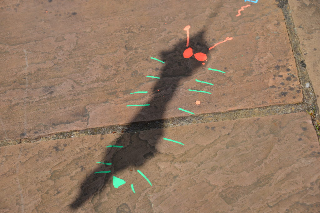 chalk drawing on the floor using a shadow