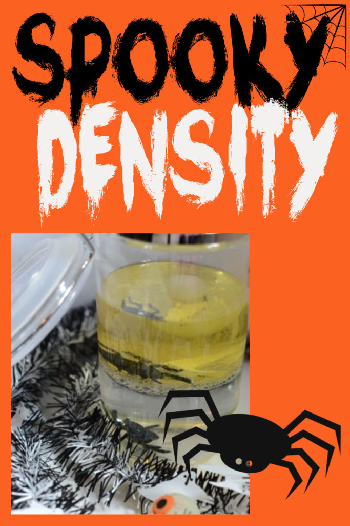 Image of a a jar with oil and water to demonstrate density. It's halloween themed as there are plastic spiders on each layer