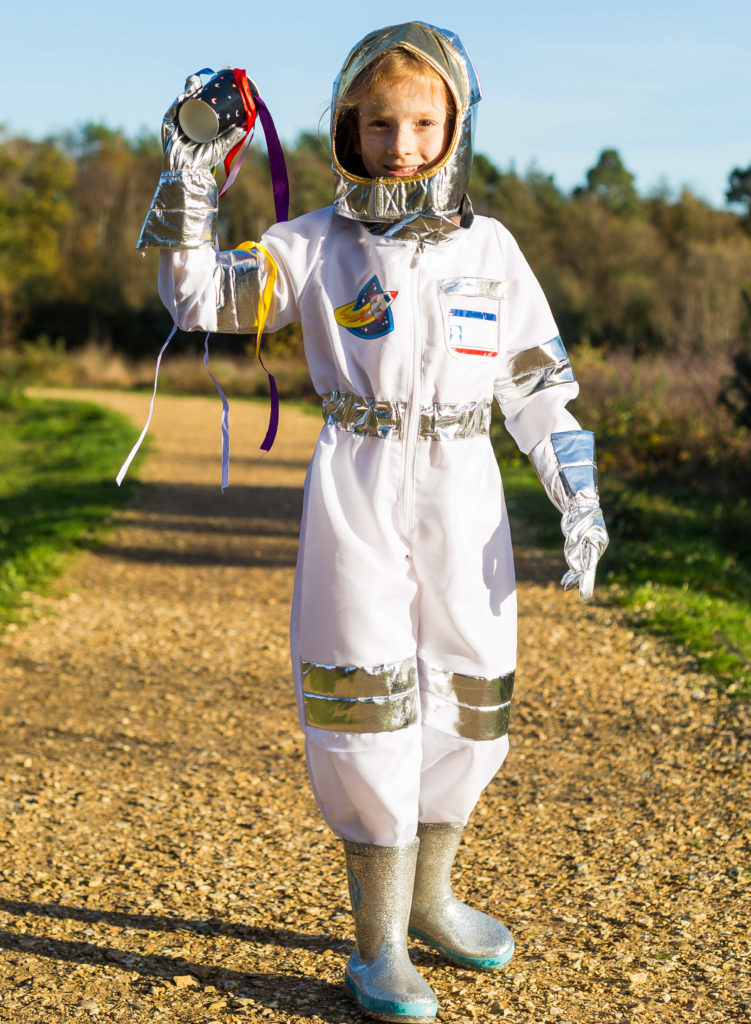 Image of a girl holding a homemade wind sock dressed as an astronaut