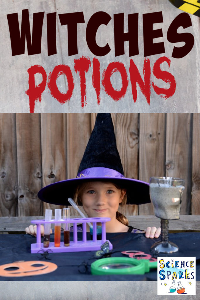 Girl dressed as a witch sat behind a table full of Halloween potions