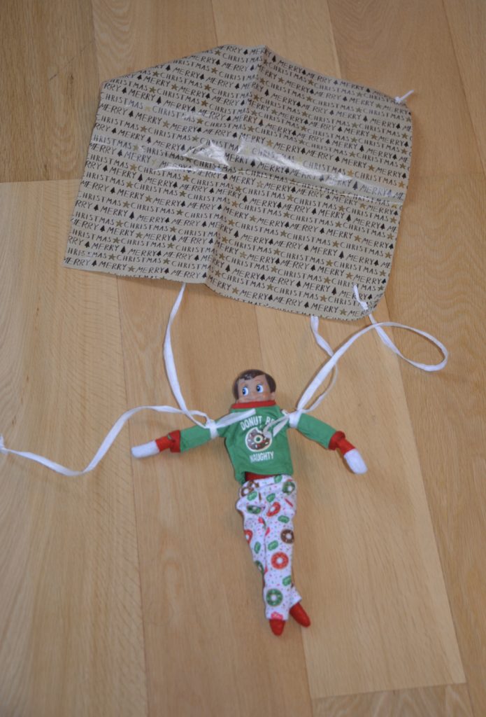 Parachute elf STEM challenge. Image shows a parachute made from gift wrap and string
