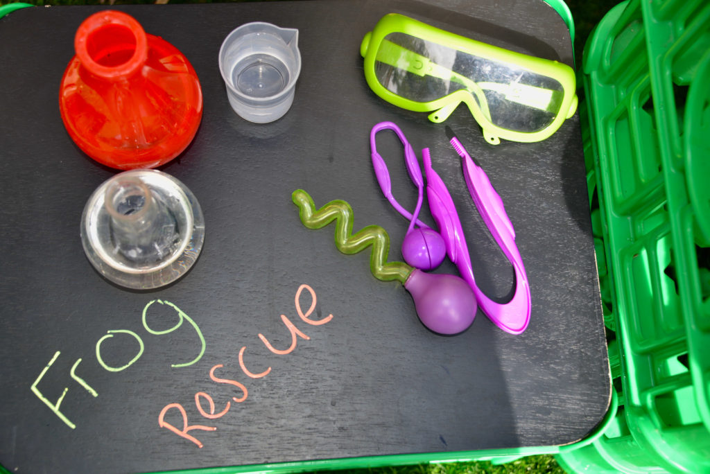 ice excavation set up with beakers and syringes for an ice activity for preschoolers