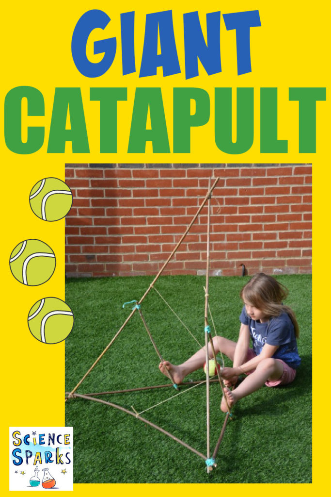 Girl sat on the floor using a large catapult and tennis ball