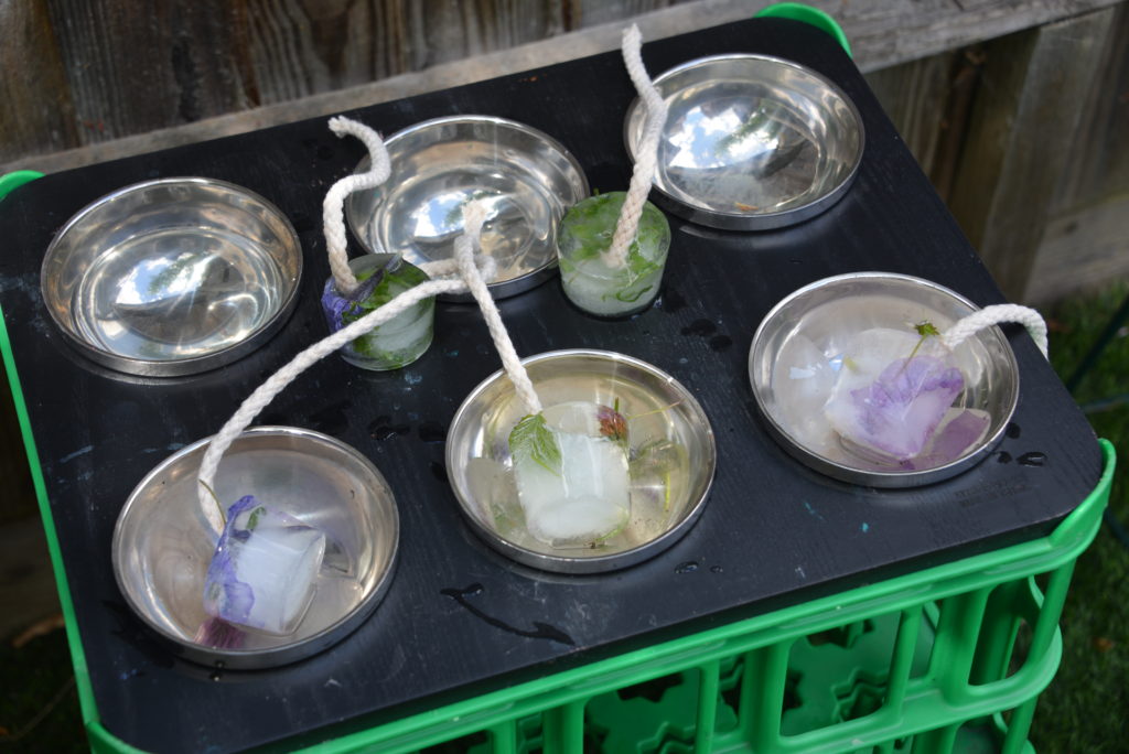 ice decorations melting in a tray as a summer STEM challenge