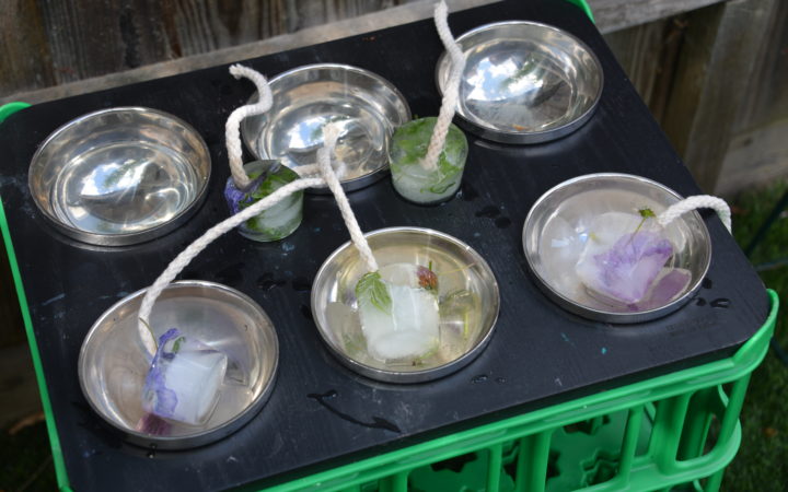 ice decorations melting in a tray as a summer STEM challenge