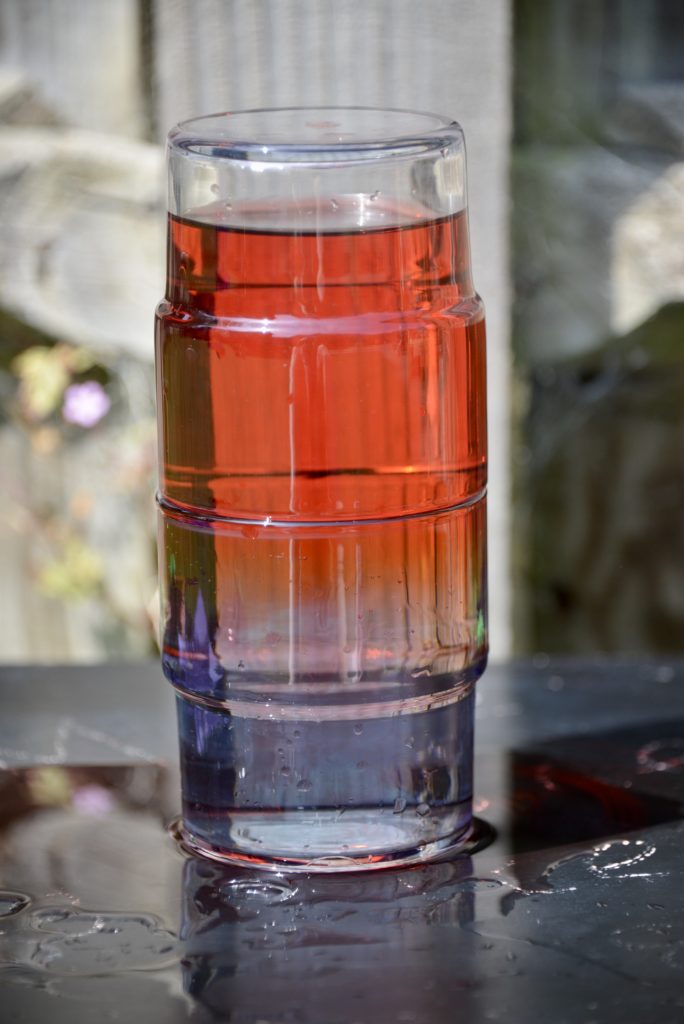 blue cold water sitting under red warmer water for a science experiment about density