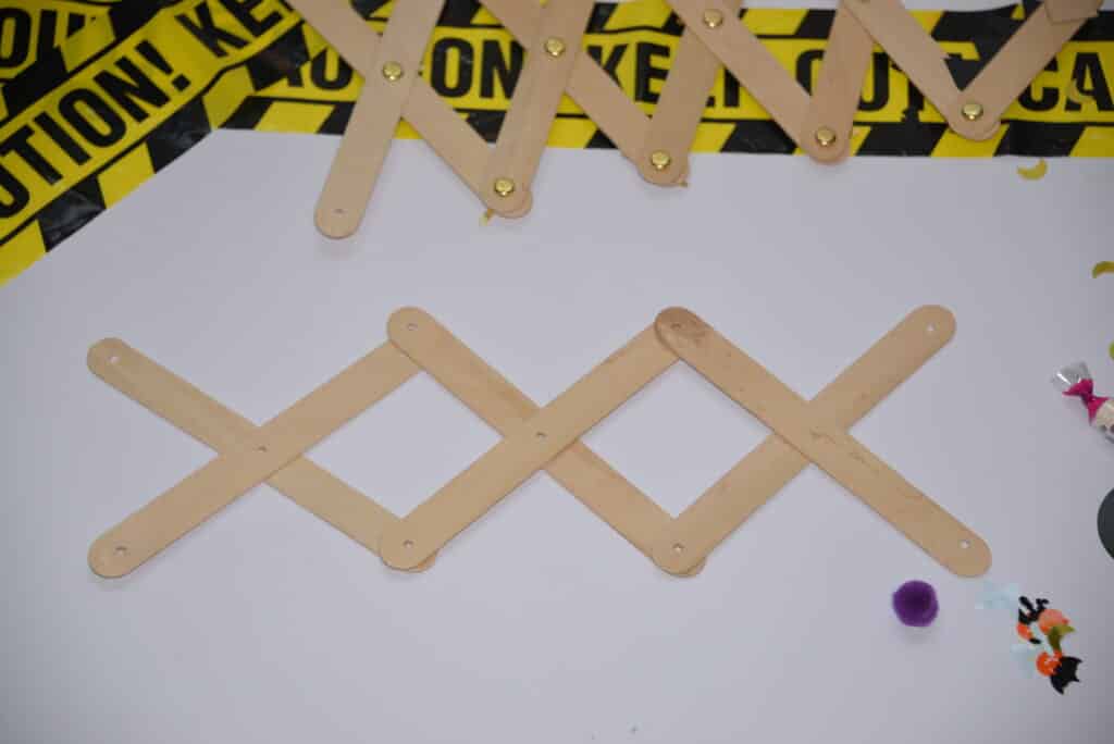Craft sticks laid out on a white background for making a grabber