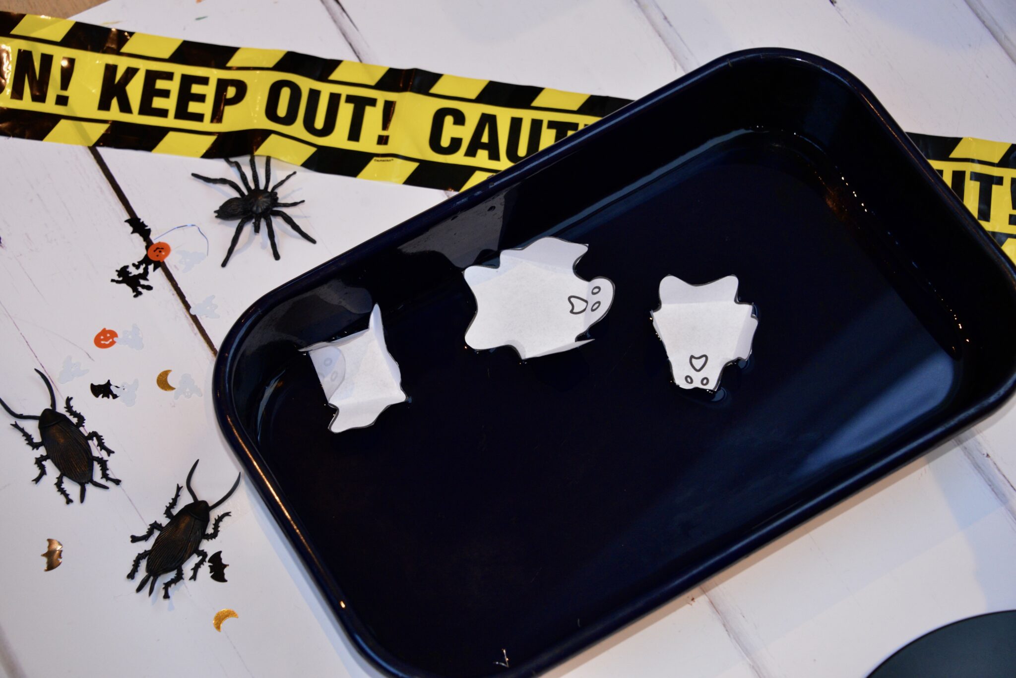 Paper ghosts in a tray of water for