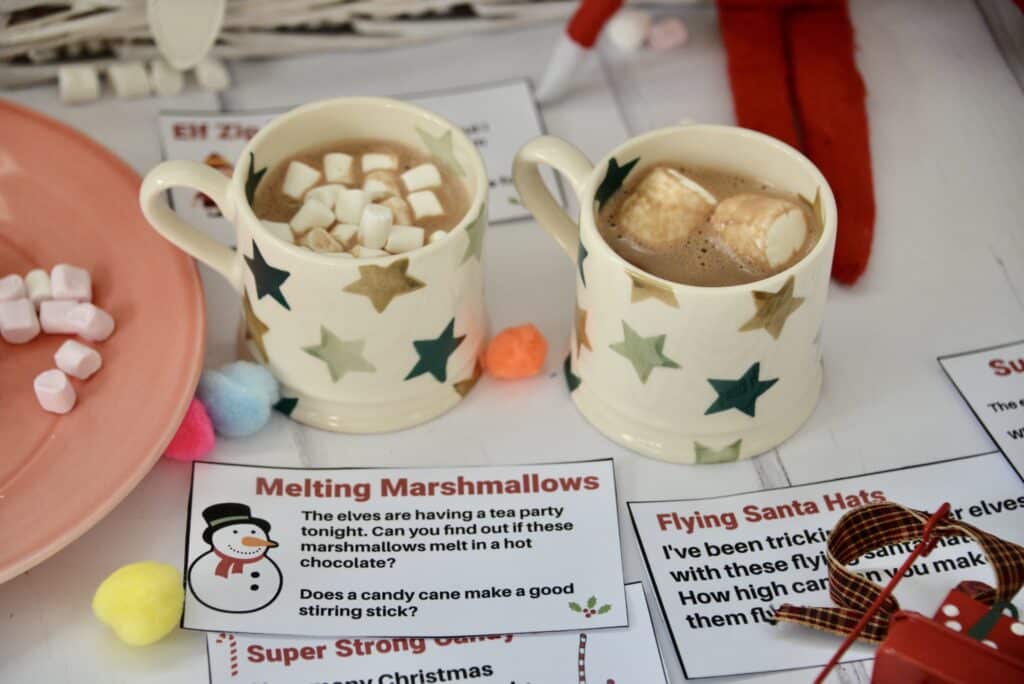 Two cups of hot chocolate, one with large marshmallows in and one small