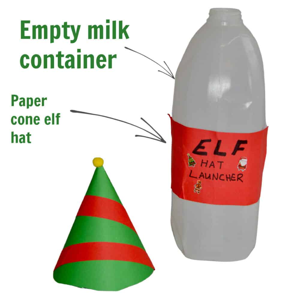 an empty milk jug and a paper cone made to look like an elf hat for an elf themed science challenge