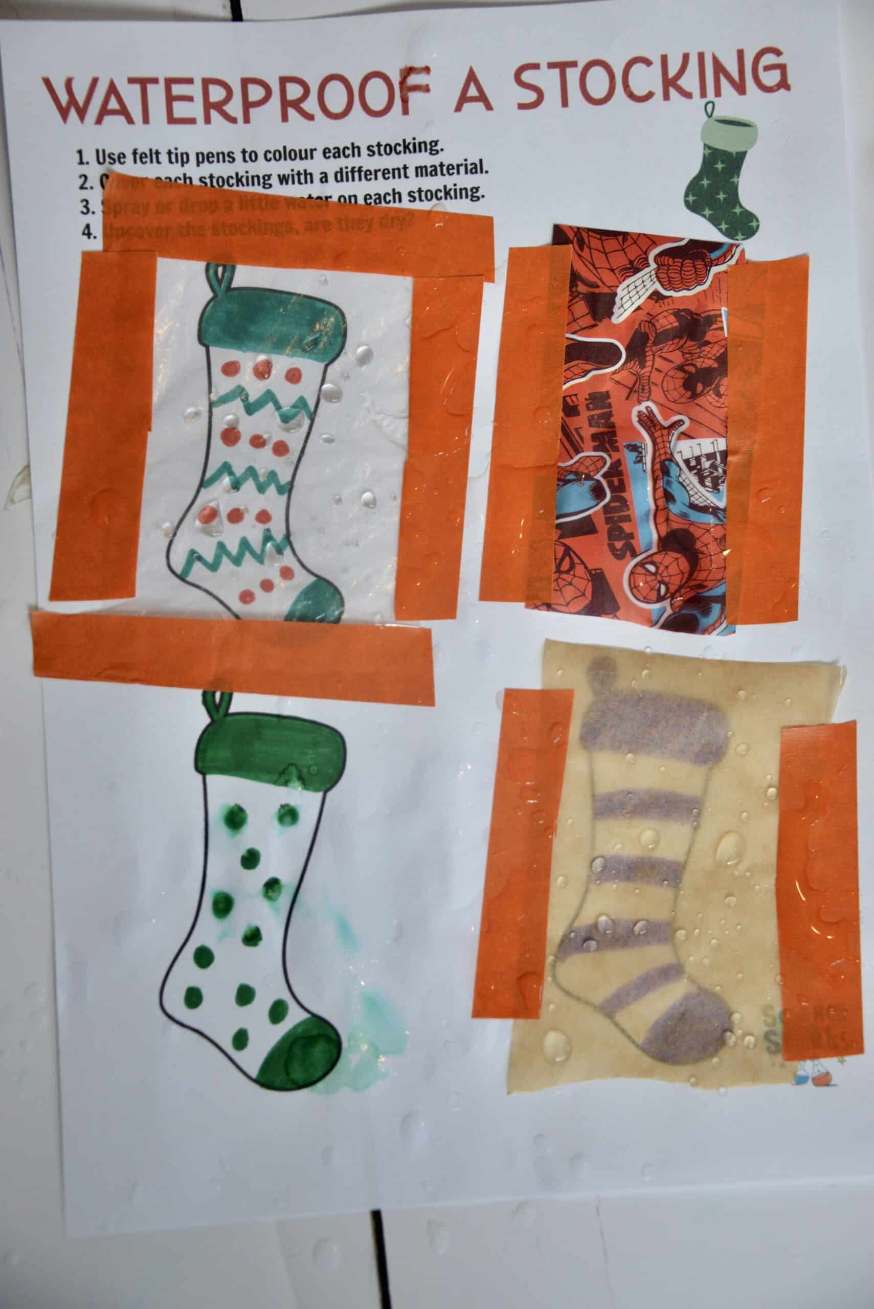 waterproofing investigation. 4 stocking shapes on A4 paper are covered in different materials and secured in place with masking tape. One is left uncovered.