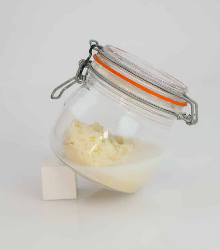 A jar filled with butter which has been made from cream