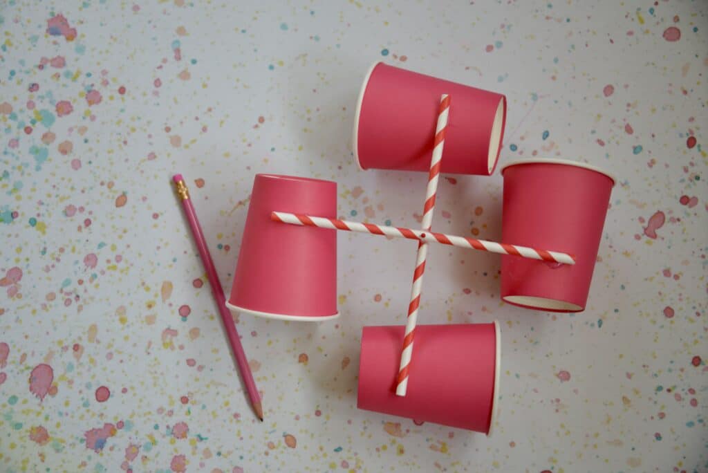 Homemade anemometer made with paper cups and 4 straws in a cross shape.