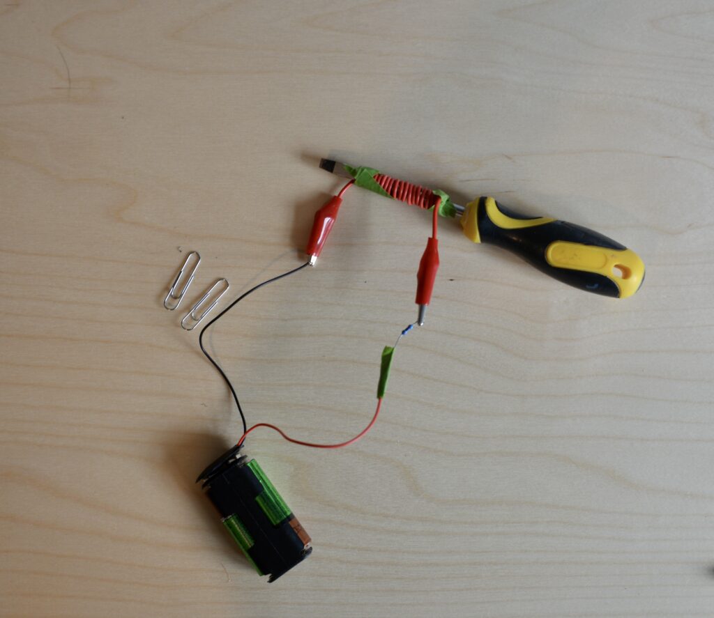 Electromagnet made using a screwdriver, batteries and long wire.