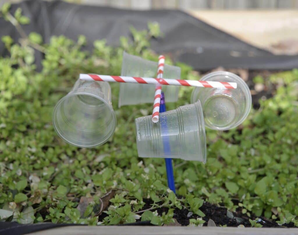 DIY anemometer made with 4 transparent cups attached to 4 straws in a cross shape