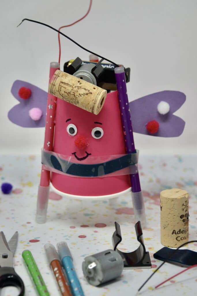 drawing robot made with a paper cup, motor, spinning cork and 3 felt tip pens.