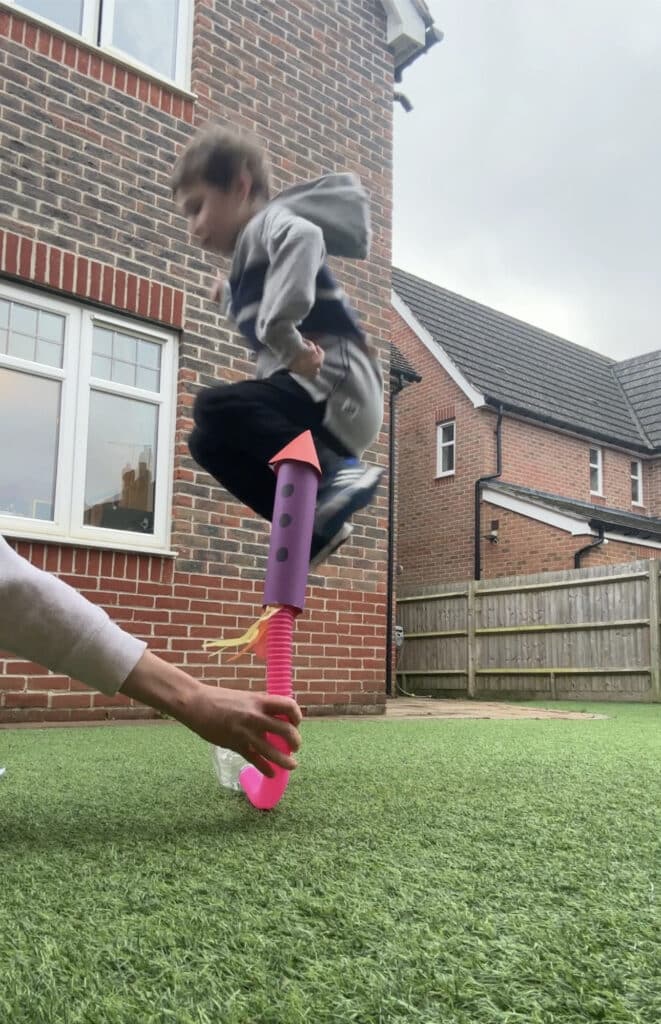 child jumping on a homemade stomp rocket