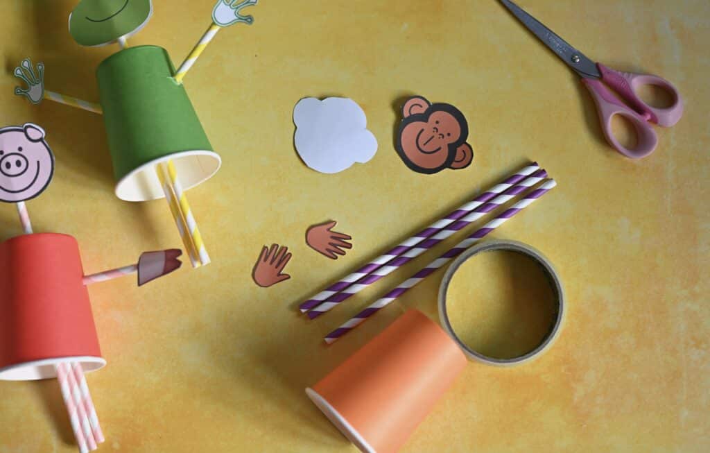 paper cup, straws and tape for making a push and pull puppet