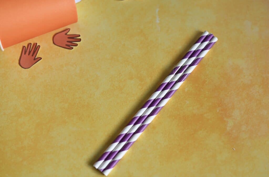 Three straws taped together for a push and pull puppet toy