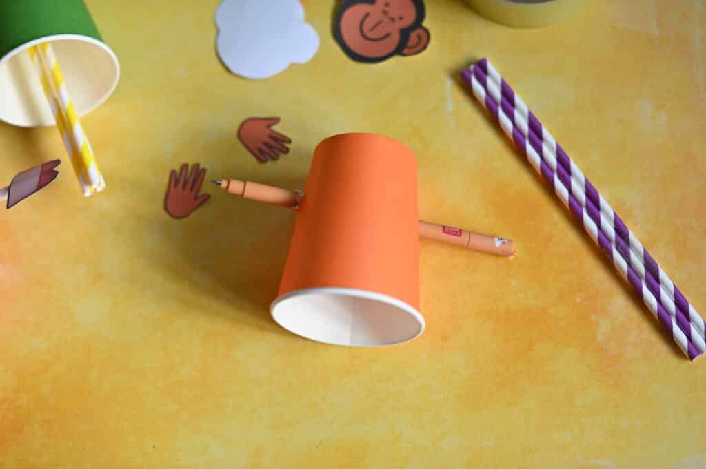 pencil pushed through a paper cup to make a puppet