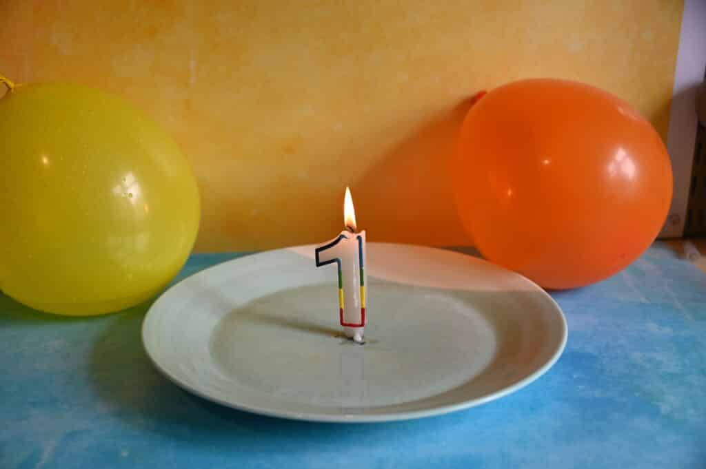 Candle on a plate and two balloons for an unpoppable balloon science activity