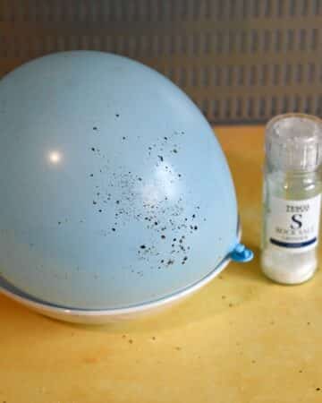 Ballon covered in pepper from a separating salt and pepper science activity