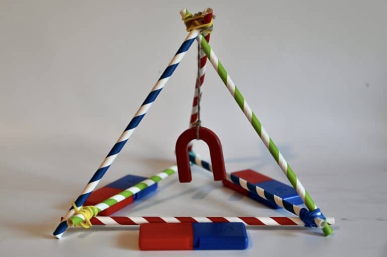 magnet hanging from a frame with other magnets around it for a magnet demonstration